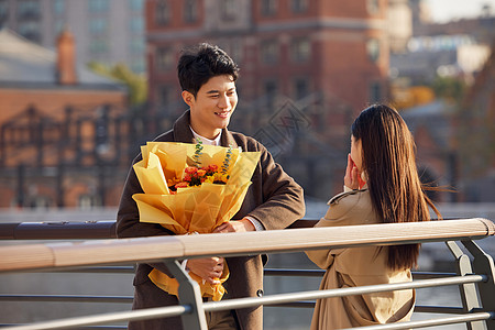 冬天户外情人节户外男性给女朋友送花背景