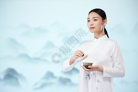 国风美女手端着茶杯背景图片