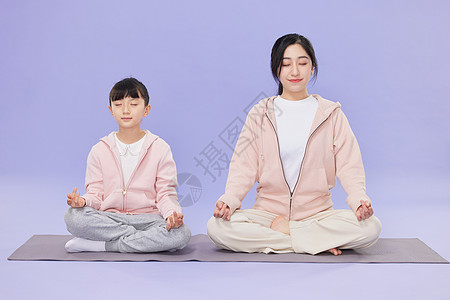母女坐在瑜伽垫上冥想图片