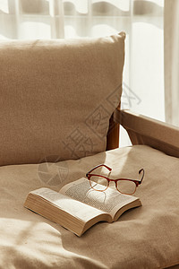 阳光下卧室里的书籍和眼镜图片
