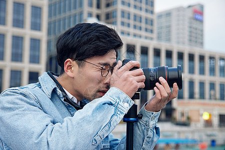 拍摄城市风光的男摄影师形象图片