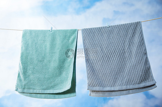 室外蓝天下晾晒着的毛巾图片