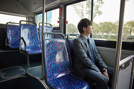 努力工作乘坐公交车上班的商务男青年背景