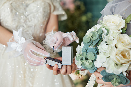 婚礼上的新娘为新郎佩戴戒指特写图片