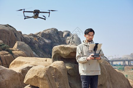 航拍摄影师山顶使用无人机拍摄山景风光图片