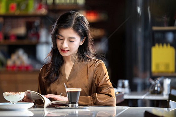 咖啡馆内在看书的青年女人图片