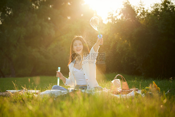 美女户外秋游野餐玩泡泡图片