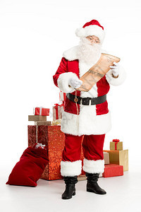 快乐的圣诞老人站在一堆圣诞礼物和一个大袋子旁边背景图片