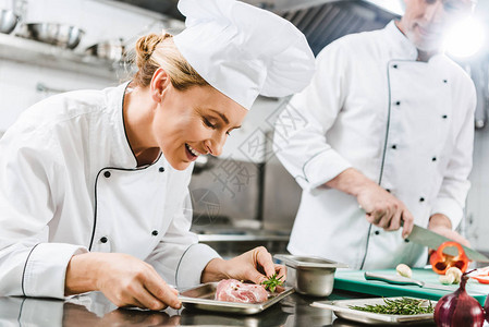 手持肉盘的女厨师笑着微笑的女厨师图片