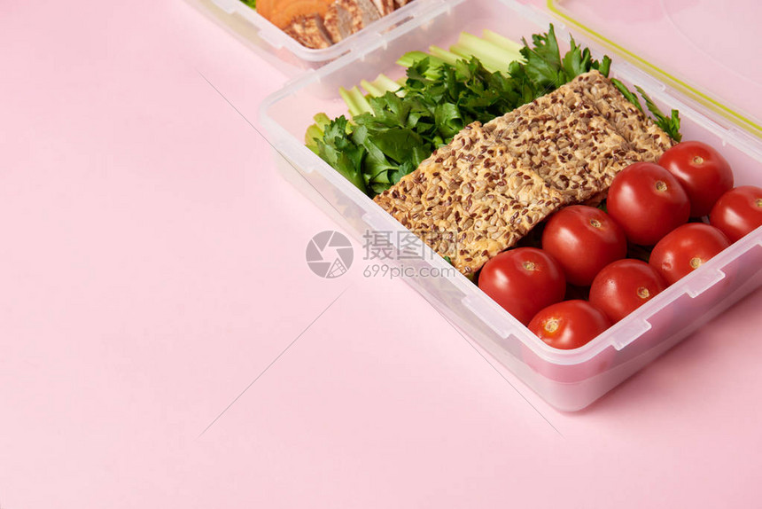 以粉红为背景的食品集装箱内健康食物图片