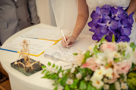 新娘和新郎在结婚文件上签字图片