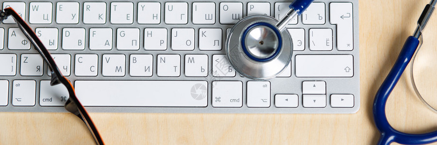 从顶部看医学生工作表键盘眼镜和听诊器都放在诊所的桌子上医疗概图片