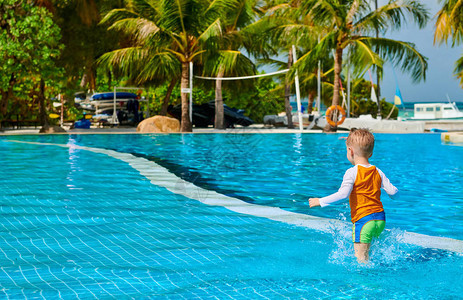三岁的小孩在度假池游泳池里在马尔代夫度图片