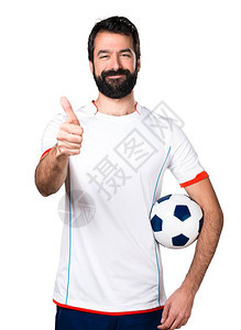 足球运动员握着一个举起图片