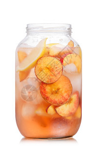 用桃轮和柠檬片装饰的碳酸桃柠檬水罐装满桃子和柠檬片的冷桃子图片