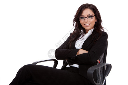 坐在办公椅子上的年轻有吸引力的天主教女商人图片