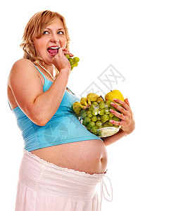 孕妇吃水果孤立图片