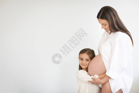 年轻漂亮的怀孕少女及其小女儿幸福家庭概图片