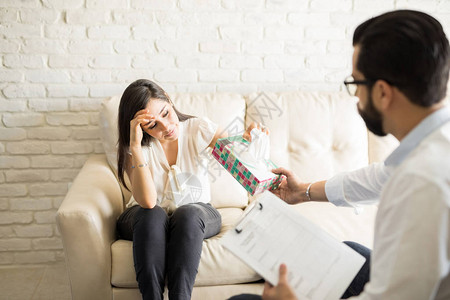 哭泣妇女与男心理医生在治疗期间交流精神问题图片