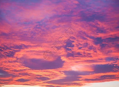 日落时天空中的红云背景图片