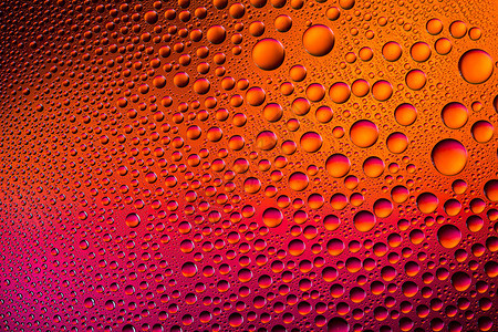 彩色水滴与梯度密封雨滴珠对玻璃盘浸渍纳米效应与橙色红紫太阳颜色运行光谱背景背景图片