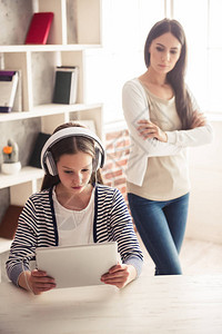 耳机上的问题十几岁的女孩正在使用数字平板电脑图片