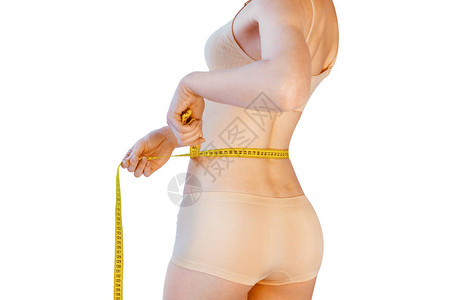 白色背景下测量腰部的瘦弱女图片