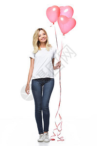 穿着便衣的漂亮女孩拿着一捆心形气球图片