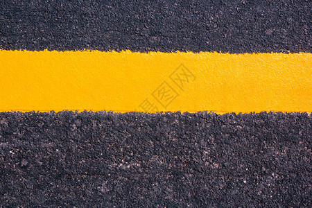 道路纹理背景上的黄线背景图片