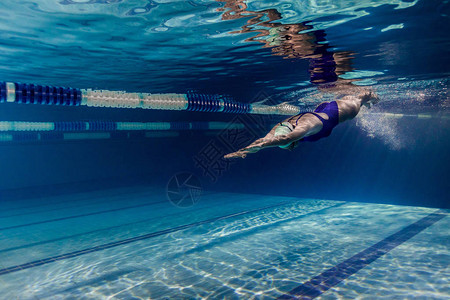 游泳衣和泳池护目镜训练中的女游泳图片