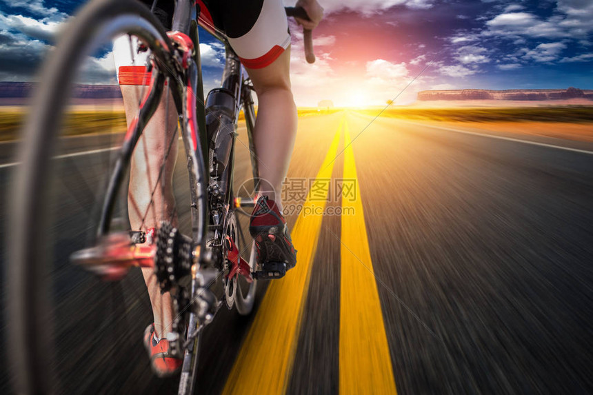 自行车道上的男骑自行车者图片