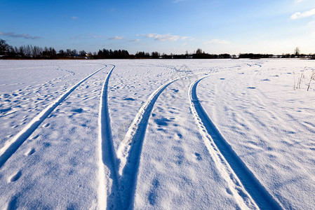 深雪中覆盖的冬季雪路车胎轨迹向背景图片