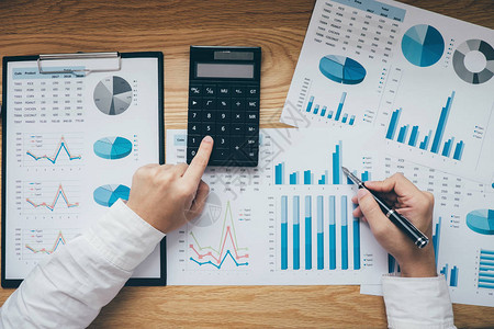 商人处理图表文档财务报告和分析计算成本图片