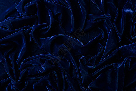 深蓝色天鹅绒纺织品为背图片
