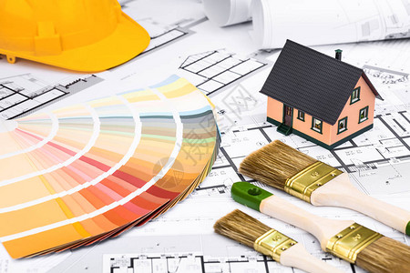 在蓝图上使用粉刷工具调色板和微型房屋的施工计划图片