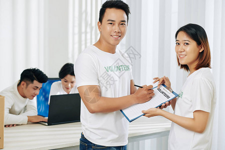 微笑的年轻越南志愿者在他们的大学报名图片