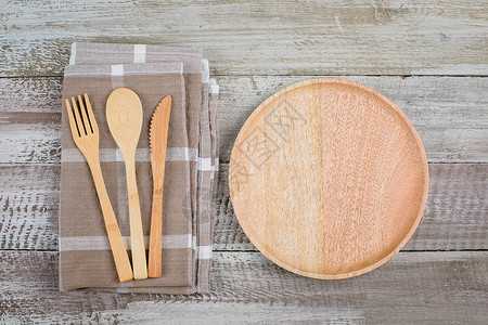 木桌背景上的木盘和餐具的顶部视图空盘子样机食品概念复制空图片