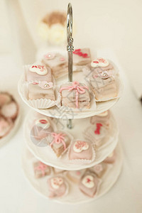 粉红白颜色的小甜点与迷人的装饰品相配巧克力图片