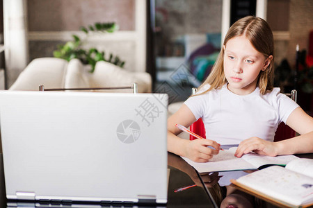 一个女孩在笔记本电脑显示器上观看视频课程图片