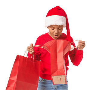 穿着圣诞老人帽子和白底袋购物袋的美籍图片