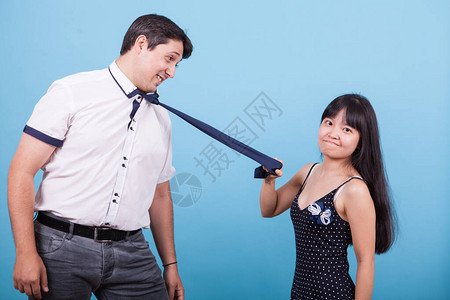 愤怒的亚洲女友拉着她的caucasian男友领图片