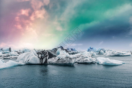 北极光下冰川融化在北极水中的风景照图片