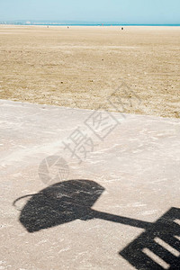 沙滩上露天篮球场的混凝土地板上的篮球背板阴影图片