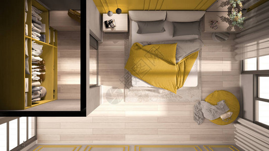 黄色调的简约经典卧室配有步入式衣橱带羽绒被和枕头的双人床边桌和地毯图片