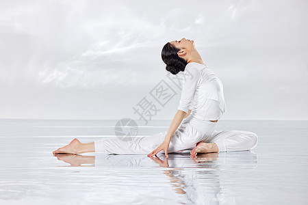 禅意水面上做瑜伽运动的女青年图片