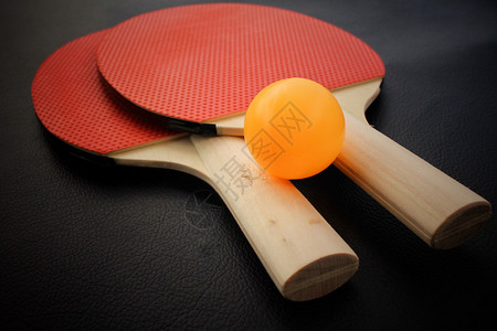 乒乓球拍：红黑色的木头桌上运动游戏背景图片