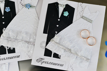 带结婚戒指的结婚请柬和白色背景上的新娘图片