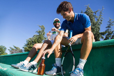 两名职业球员在一场艰苦的网球比赛后补水图片