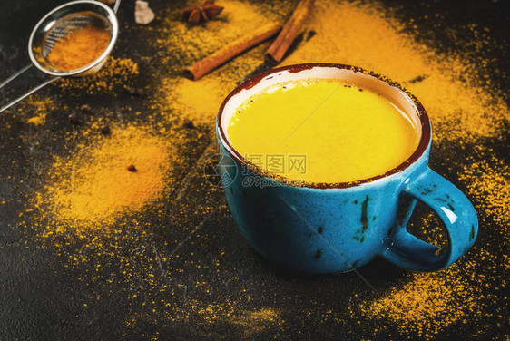 传统的印度饮料姜黄牛奶是带有肉桂丁香胡椒和姜黄的金色牛奶图片