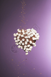 巧克力心形糖果配棉花糖和坠落的碎巧克力图片